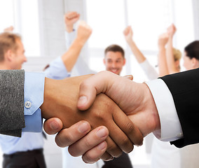 Image showing businessman and businesswoman shaking hands