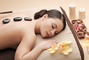 Image showing asian woman in spa with hot stones