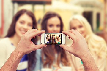 Image showing close up of hands taking picture with smartphone