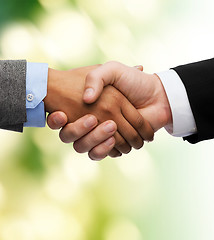 Image showing businessman and businesswoman shaking hands