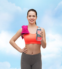 Image showing sporty woman with towel and water bottle