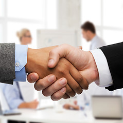 Image showing businessman and businesswoman shaking hands