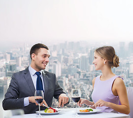 Image showing smiling couple eating main course at restaurant