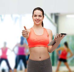 Image showing sporty woman with tablet pc computer