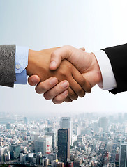 Image showing businessman and businesswoman shaking hands