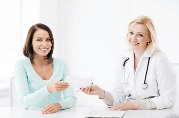 Image showing doctor giving prescription to patient in hospital