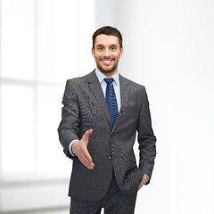 Image showing businessman with open hand ready for handshake