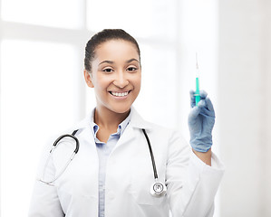 Image showing african doctor holding syringe with injection