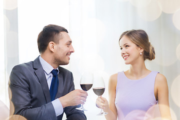 Image showing young couple with glasses of wine at restaurant