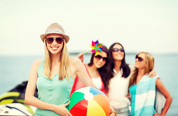 Image showing girl with ball and friends on the beach