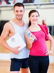 Image showing two smiling people with scale in the gym