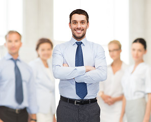 Image showing handsome businessman with crossed arms