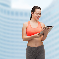 Image showing sporty woman with tablet pc computer