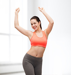 Image showing smiling teenage girl in sportswear dancing