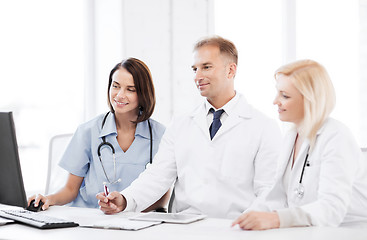 Image showing doctors looking at computer on meeting