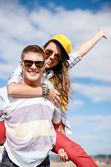 Image showing smiling teenagers in sunglasses having fun outside