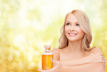 Image showing happy woman with oil bottle