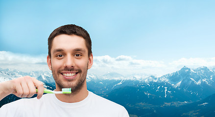 Image showing smiling young man with toothbrush