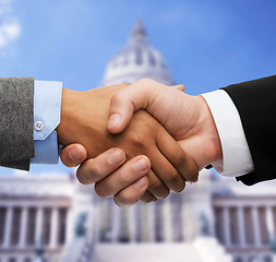 Image showing businessman and businesswoman shaking hands