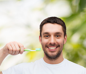 Image showing smiling young man with toothbrush