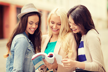 Image showing beautiful girls looking into tourist book in city