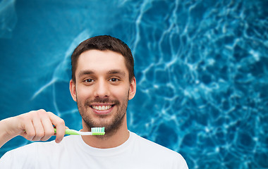 Image showing smiling young man with toothbrush