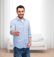 Image showing smiling man pointing finger at you