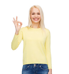 Image showing young businesswoman showing ok sign