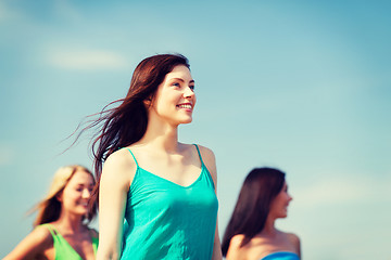 Image showing girl with friends walking on the beach