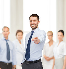 Image showing handsome businessman pointing finger at you