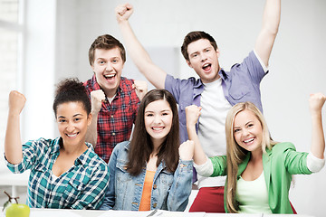 Image showing students holding hands up at school