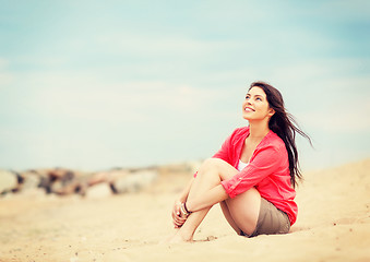 Image showing girl sitting on the beach