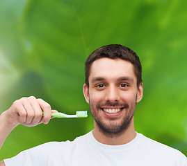 Image showing smiling young man with toothbrush