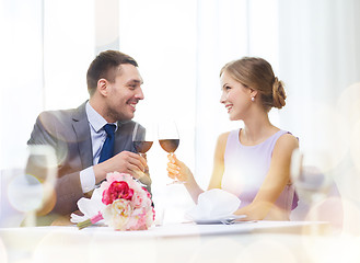 Image showing young couple with glasses of wine at restaurant