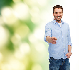 Image showing smiling man pointing finger at you