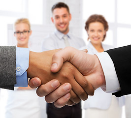 Image showing businessman and businesswoman shaking hands