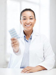 Image showing doctor with blister packs of pills