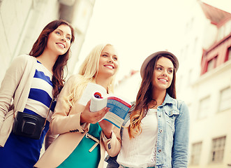 Image showing three beautiful girls with tourist book in city