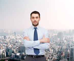 Image showing handsome businessman with crossed arms