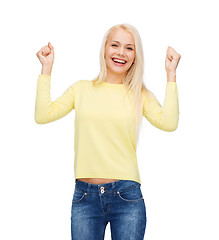 Image showing laughing young woman with hands up