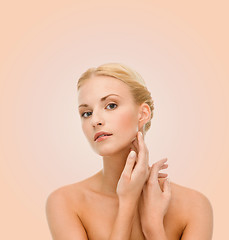 Image showing beautiful woman touching her face skin