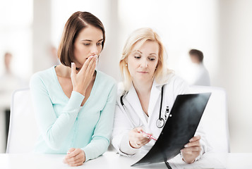 Image showing doctor with patient looking at x-ray