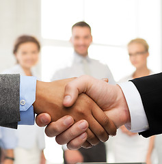 Image showing businessman and businesswoman shaking hands