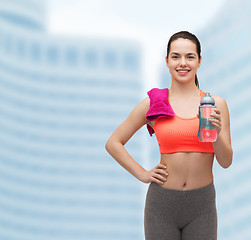 Image showing sporty woman with towel and water bottle