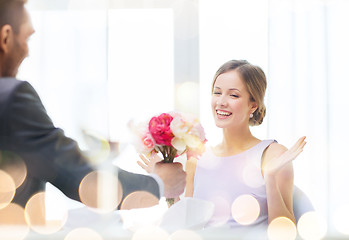 Image showing amazed woman recieving bouquet of flowers