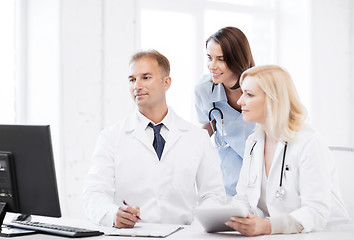 Image showing doctors looking at computer on meeting