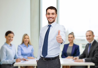 Image showing handsome businessman showing thumbs up