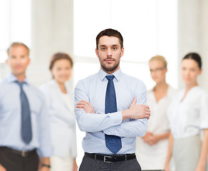 Image showing handsome businessman with crossed arms