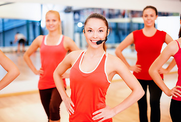 Image showing group of smiling people exercising in the gym