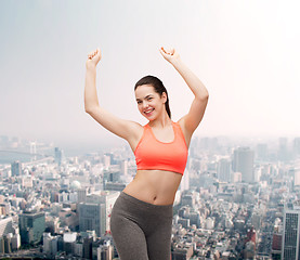 Image showing smiling teenage girl in sportswear dancing